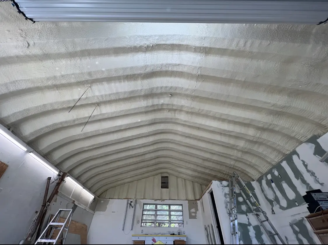 Spray polyurethane foam applied to the underside of a metal roof deck in Wasco